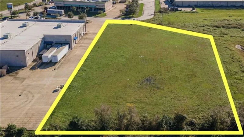Aerial view of a 1.46 acre commercial lot outlined in a cleared field, Alvin, Texas