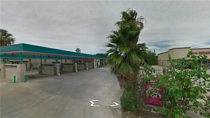 Self serve car wash bays with covered roof on a corner lot, Houston, Texas